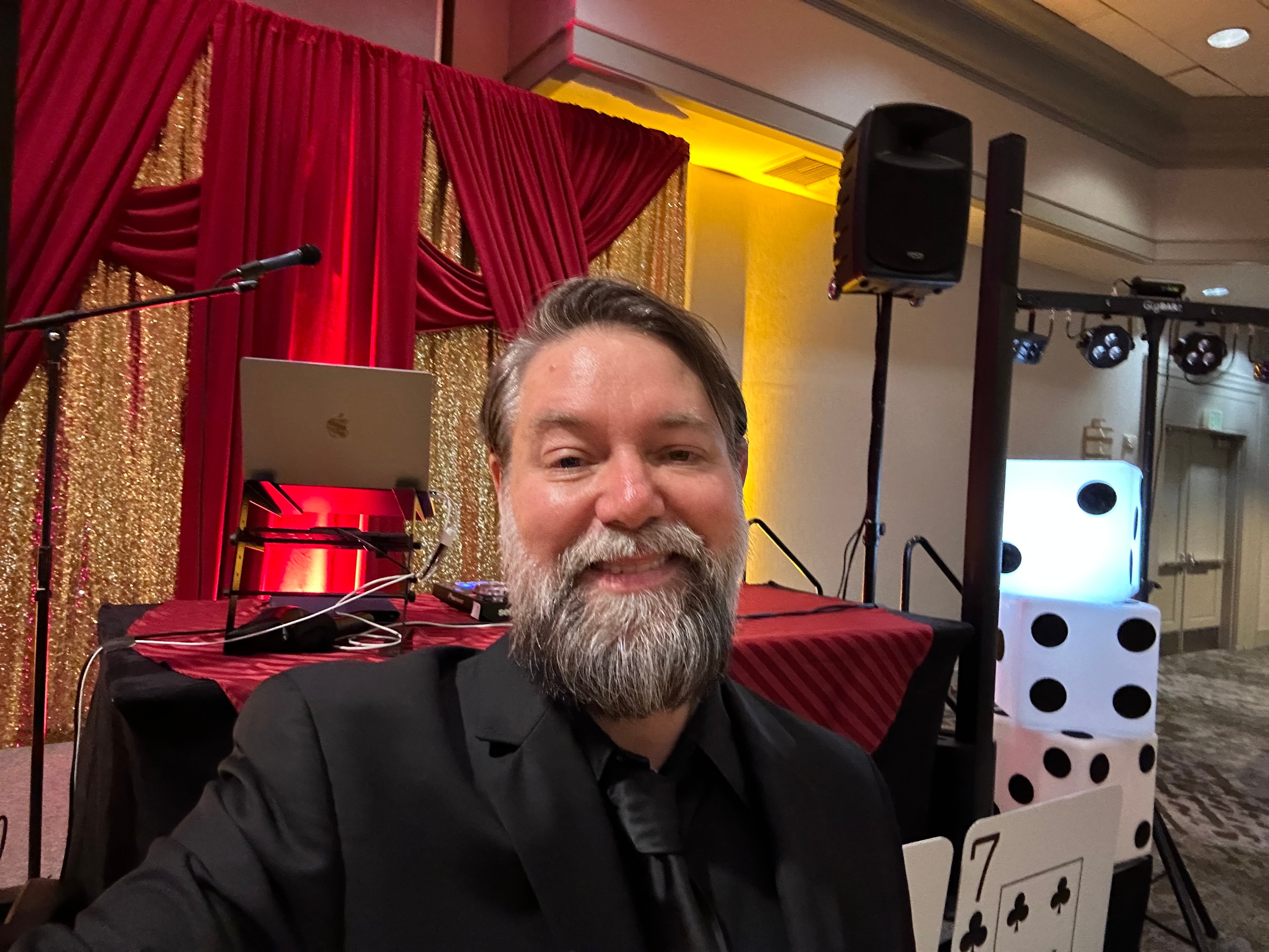 DJ at casino-themed corporate event with gold and red decor